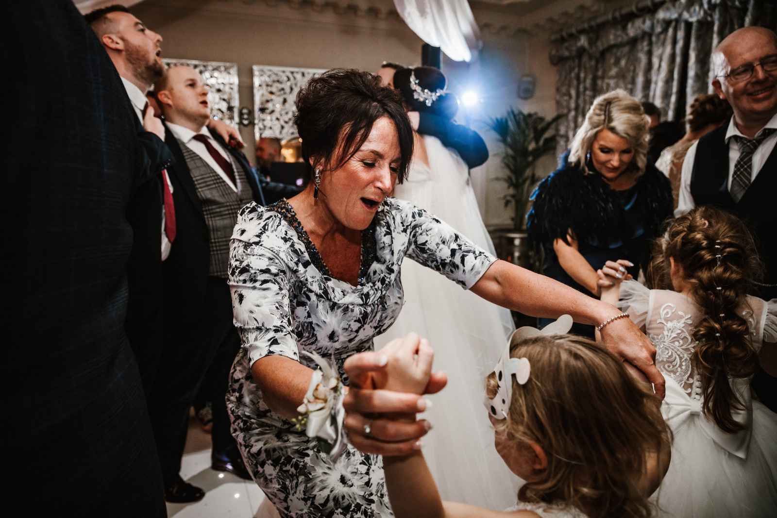 Mother of the bride dancing with flower girl