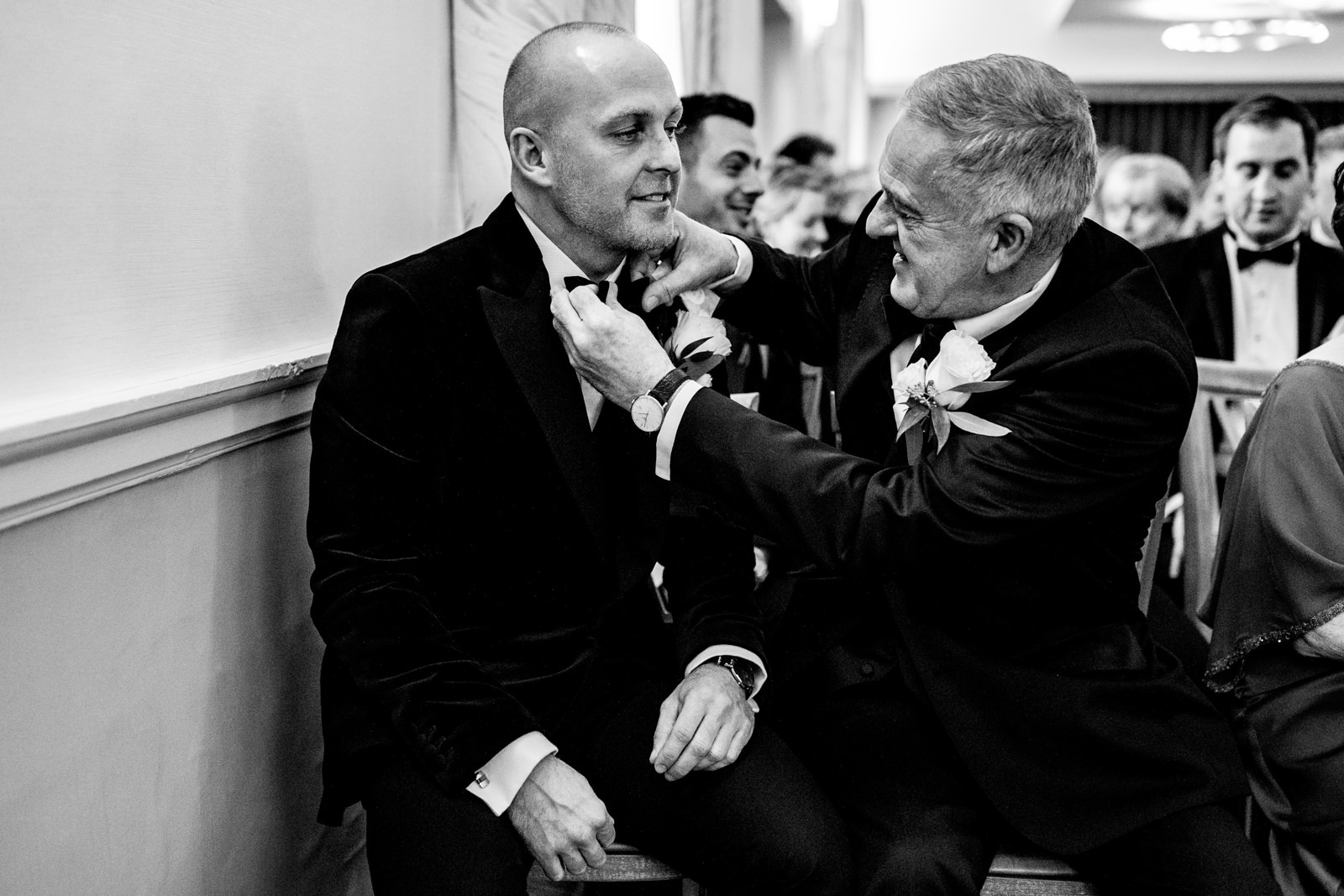 Groom getting his tie fixed by his father